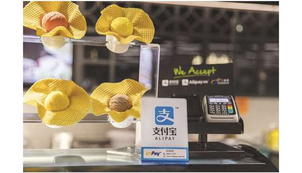 A sign for digital payment service Ant Financialu2019s Alipay, an affiliate of Alibaba Group Holding, stands in front of a payment terminal at a gelato counter at the Food Le Parc supermarket in Hong Kong. Ant  Financial has applied for a digital banking licence in Singapore, as Chinau2019s largest online financial  platform steps up efforts to expand outside the mainland.