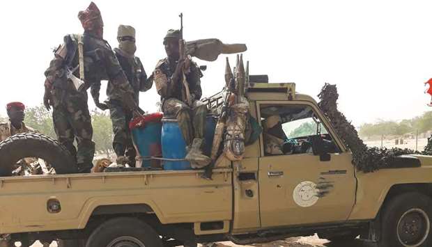 Soldiers of the Chad Army sit on the back of a Land Cruiser at the Koundoul market, 25km from Nu2019Djamena, upon their return after a months-long mission fighting Boko Haram in neighbouring Nigeria.