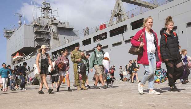 Evacuees from Mallacoota arrive on the navy ship HMAS Choules at the port of Hastings, Victoria, yesterday.
