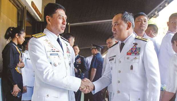 Outgoing Armed Forces of the Philippines chief Lt Col Noel Clement (left) shakes the hand of his successor, Lt. Gen. Felimon Santos Jr, during the change-of-command ceremony at Camp Aguinaldo in Quezon City, yesterday.