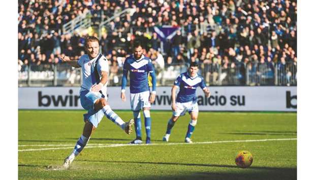Laziou2019s Ciro Immobile shoots and scores a penalty kick during the Serie A match against Brescia in Brescia, Italy, yesterday. (AFP)