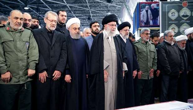 Iran's Supreme Leader Ayatollah Ali Khamenei and Iranian President Hassan Rouhani pray near the coffin of Iranian Major-General Qassem Soleimani, head of the elite Quds Force, who was killed in an air strike at Baghdad airport, in Tehran