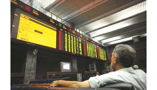 Pakistani investor monitors the index at the Karachi Stock Exchange (file). After two gloomy years of negative stock returns, equities managed to provide a 10% return for 2019, thanks to spectacular 42% gains recorded in the last four and a half months when the KSE-100 index rebounded on August 16 from its five-year low of 28,765 points to close at 40,735 points on December 31.