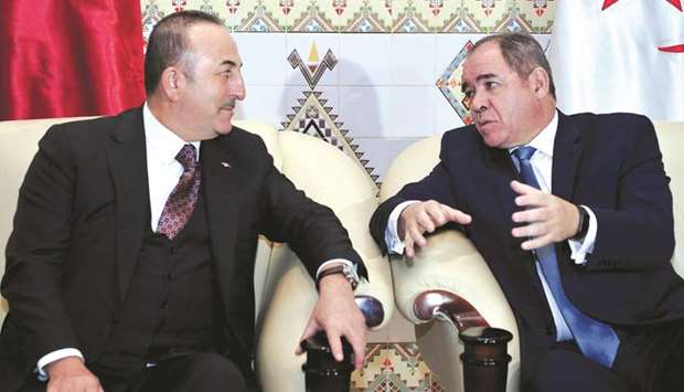A handout picture released by the official Algeria Press Service (APS) yesterday shows Algeriau2019s Foreign Minister Sabri Boukadoum (right) meeting with his Turkish counterpart Mevlut Cavusoglu upon his arrival in Algiers for talks on the Libyan crisis.