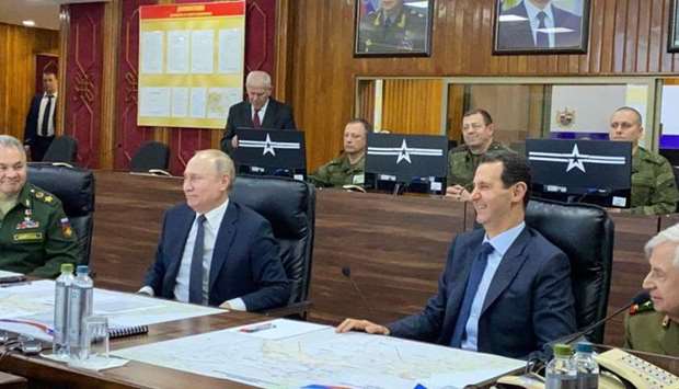 President Bashar al-Assad (C-R) meeting with his Russian counterpart Vladimir Putin (C-L) at the headquarters of the Russian forces in the Syrian capital Damascus. AFP/HO/Syrian Presidency Telegram page