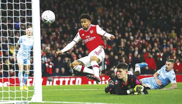Arsenalu2019s Reiss Nelson scores their first goal against Leeds United in their FA Cup third round match in London on Monday. (Reuters)