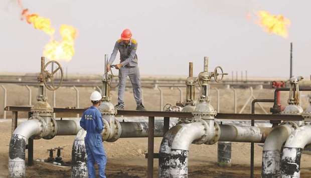 Iraqi labourers work at an oil refinery in the southern town Nasiriyah (file).