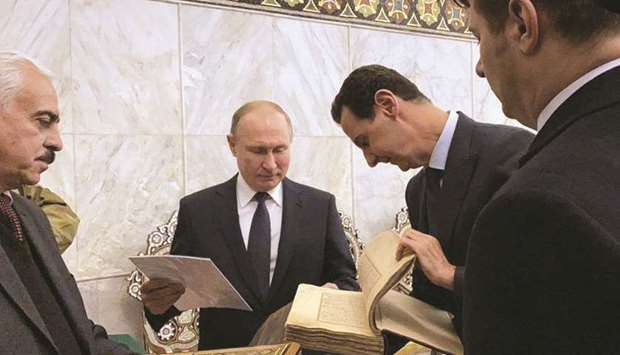 A handout picture released by the official Syrian presidency yesterday shows President Bashar al-Assad visiting with his Russian counterpart Vladimir Putin Damascusu2019 historic Ummayad Mosque in the Old City of the Syrian capital.
