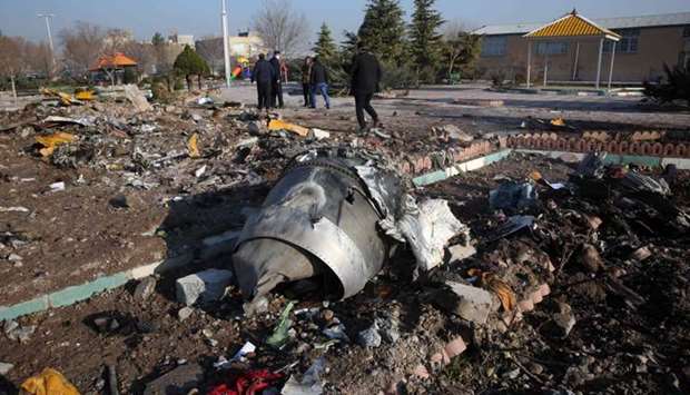 Rescue teams work amidst the debris of crashed Ukraine International Airlines Boeing 737