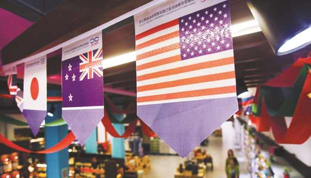 A US flag (right) at a store in the Nantong Free Trade Zone in Chinau2019s eastern Jiangsu province. Accustomed to unfulfilled promises from the Chinese government, foreign businesses are keeping a wary eye on a nascent law aimed at addressing their long-standing grievances about unfair treatment in the worldu2019s second largest economy.