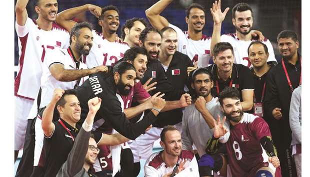 Qatar players and officials celebrate their victory over Australia yesterday.