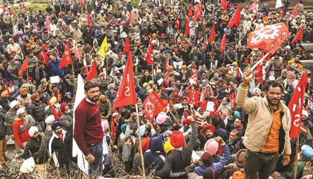 Activists of Communist Party of India Marxist (CPIM), along with members of different workers unions, shout slogans as they block train tracks during a nationwide general strike called by trade unions aligned with opposition parties to protest against the Indian governmentu2019s economic policies, near the railway station in Amritsar yesterday.