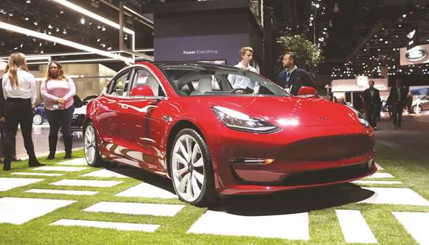 The Tesla Model 3 is displayed during AutoMobility LA, ahead of the Los Angeles Auto Show on November 29, 2018. The Model 3 sold in serious volume, with website InsideEVs.com estimating almost 160,000 sales for the year. Other automakers investing billions to roll out electric models have serious catching up to do.