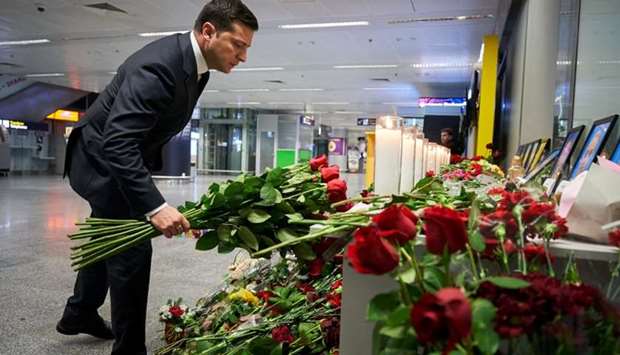 Ukrainian President Volodymyr Zelenskiy lays flowers to commemorate victims of the Ukraine International Airlines Boeing 737-800 plane crash, at a memorial in Boryspil International airport outside Kiev, Ukraine