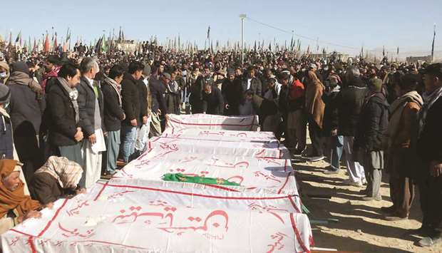 People gather near the coffins of coalminers, who were killed in an attack in the Machh area of Bolan district, during a funeral in Quetta.