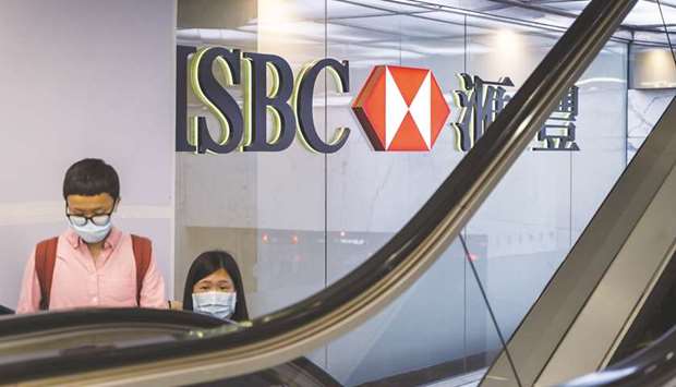 Customers use an escalator at the HSBC Holdings headquarters building in Hong Kong. ShareAction said investors recognise HSBC has made progress on climate-change matters, yet theyu2019ve also called for the bank to do more and said its net-zero strategy contains no specific plans for phasing out its exposure to coal, oil and gas.