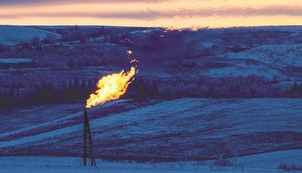 A natural gas flare on an oil well pad burns as the sun sets outside Watford City, North Dakota (file). The US, which had been one of Opecu2019s biggest customers, has cut its monthly imports by about 50% since mid-2006.