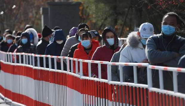 Residents line up to be tested for the Covid-19 coronavirus in Beijing