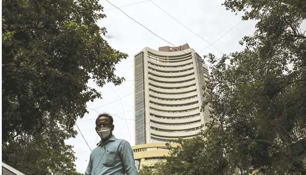 A pedestrian walks near the Bombay Stock Exchange in Mumbai. The S&P BSE Sensex climbed 1% to 49,269.3 points yesterday.
