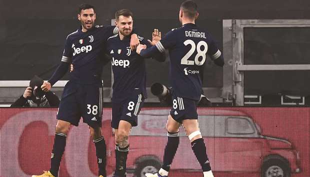 Juventusu2019 Aaron Ramsey (centre) celebrates with teammates Gianluca Frabotta (left) and Merih Demiral after scoring against Sassuolo in Serie A on Sunday. (AFP)