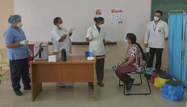 Health professionals brief a volunteer (2R) during a dry run or mock drill for the Covid-19 coronavirus vaccine delivery held at a private medical college in Bangalore