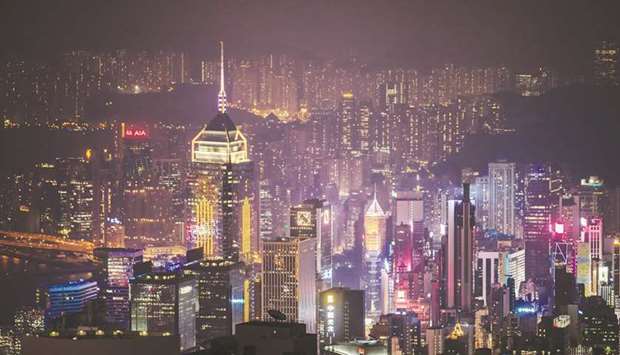 Buildings are seen from Victoria Peak at night in Hong Kong. In a year disrupted by a global pandemic, political upheaval and abrupt setbacks for some of Hong Kongu2019s biggest stocks, investors point to one constant as to why 2021 looks brighter: Relentless levels of money coming in.