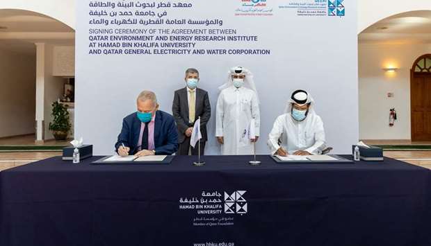 Kahramaa and HBKU officials at the agreement signing ceremony.