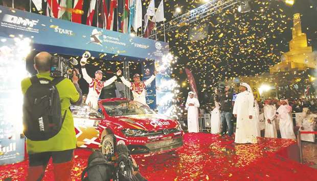 Qataru2019s Nasser Saleh al-Attiyah and co-driver Matthieu Baumel celebrate their victory in the 2019 Qatar International Rally at Souq Waqif in Doha.