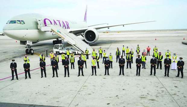 One of the new Boeing 777 freighters of Qatar Airways Cargo seen after its arrival in Doha with the crew of the three aircraft, and support and ground staff.
