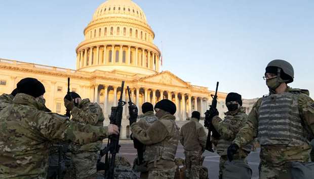 Members of the national guard gather outside the US Capitol.