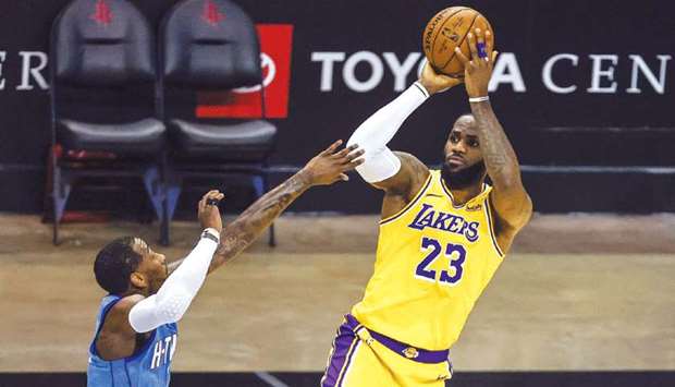 Los Angeles Lakers forward LeBron James (right) shoots the ball against Houston Rockets guard John Wall during the second quarter of their NBA game at Toyota Center in Houston, Texas, USA. (USA TODAY Sports)