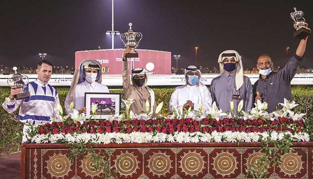 Qatar Racing and Equestrian Club Racing manager Abdulla Rashid al-Kubaisi (third from right) with the winners of Umm Al Afai Cup after Nasser Saeed al-Eidau2019s Return To Senders won the 1100m sprint at Al Rayyan Park yesterday. PICTURES: Juhaim