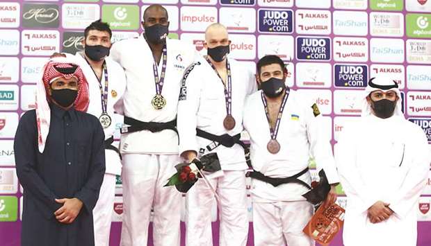 Qatar Olympic Committee President HE Sheikh Joaan bin Hamad al-Thani crowns the winners of menu2019s +100kg category of the Doha Masters judo tournament at the Lusail Multipurpose Hall yesterday. PICTURES: Jayan Orma