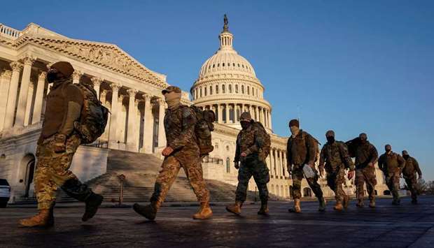 Members of the National Guard arrive at the US Capitol as Democratic members of the House prepare an article of impeachment against US President Donald Trump in Washington