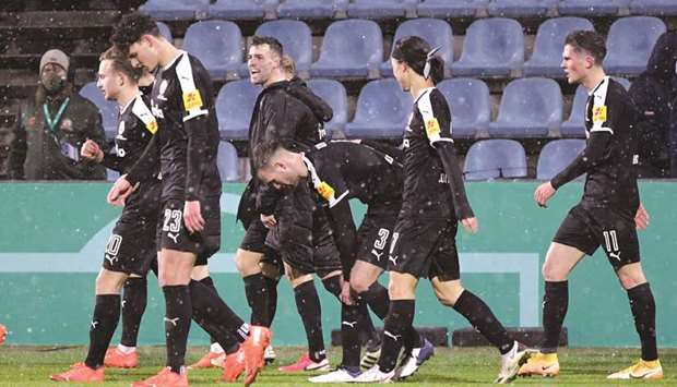 Holstein Kielu2019s players celebrate after their win over Bayern Munich in the second round of the German Cup in Kiel. (Reuters)