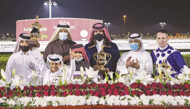 Qatar Racing and Equestrian Club Racing manager Abdulla Rashid al-Kubaisi (second from right) with the winners of Muaither Cup after Osama Omer al-Dafeau2019s Taxiwala won the 1,000m feature race at Al Rayyan Park yesterday. PICTURES: Juhaim