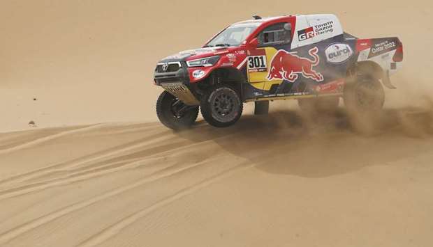 Toyota Gazoo Racingu2019s Nasser al-Attiyah of Qatar and co-driver Matthieu Baumel of France in action during stage 11 of the Dakar Rally between Al Ula and Yanbu in Saudi Arabia yesterday. (Reuters)
