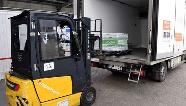 A worker unloads from a truck a special box containing the first shipment of Moderna's Covid-19 vaccine as 7,200 pieces arrived in Budapest on January 12.