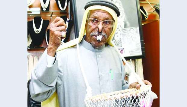 Saad Ismail al-Jassim poses with a clip on his nose and a net basket around his neck. PICTURES: Jayan Orma