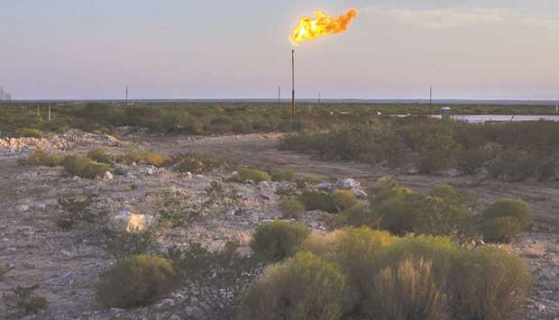 A gas flare burns at dusk in the Permian Basin in Texas (file). US total oil supply will rise by 370,000 bpd in 2021 to 17.99mn bpd, Opec said in a monthly report, up 71,000 bpd from the previous forecast.
