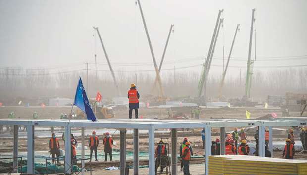 Workers at the construction site of the centralised medical observation centre, a makeshift facility to isolate people at risk of contracting the Covid-19 coronavirus in Shijiangzhuang, in northern Chinau2019s Hebei province on January 15. China is expected to be the only major world economy to post positive 2020 growth.