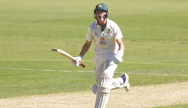 Australiau2019s Marnus Labuschagne celebrates reaching his century against India at the Gabba in Brisbane yesterday.
