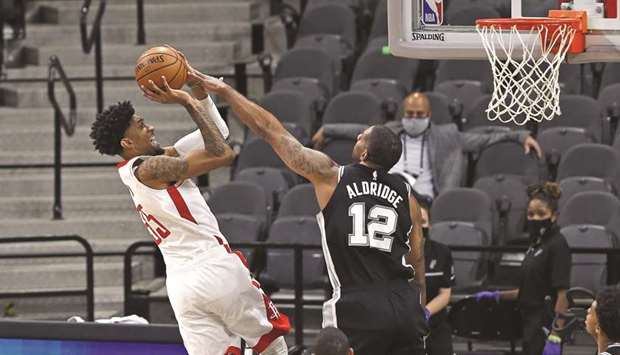 Christian Wood (left) of the Houston Rockets shoots over LaMarcus Aldridge of the San Antonio Spurs during the NBA game at AT&T Center in San Antonio, Texas, United States, on Thursday. (AFP)