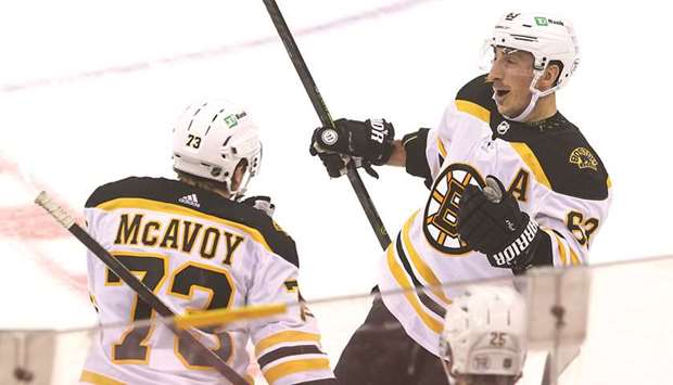 Boston Bruins center Brad Marchand (right) celebrates his game-winning goal against the New Jersey Devils at Prudential Center in Newark, New Jersey, United States, on Thursday. (USA TODAY Sports)