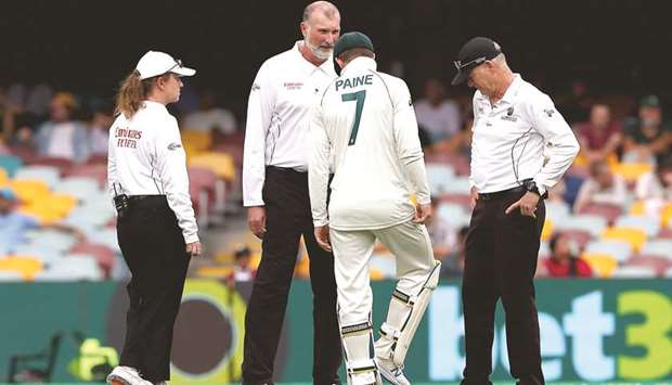 Australiau2019s captain Tim Paine and the umpires examine the pitch after rain on day two of the fourth Test against India yesterday. (AFP)