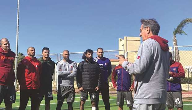 Qatar coach Valero Rivera (right) speaks to his players Saturday ahead of the Group C clash against Japan in the IHF Menu2019s World Championship at Borg El Arab near Alexandria. PICTURE: Noushad Thekkayil