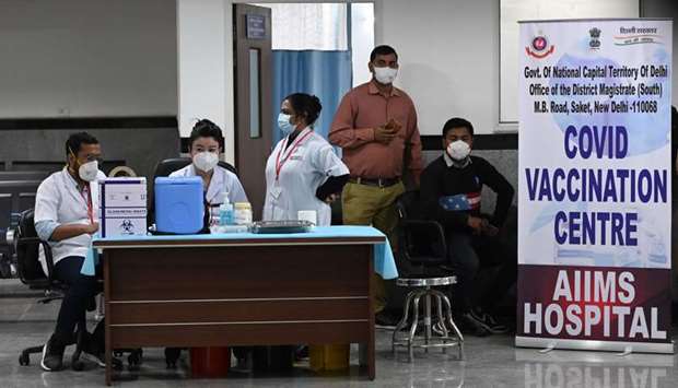 Health workers wait for the start of the Covid-19 coronavirus vaccination drive at the All India Institute of Medical Science (AIIMS) in New Delhi