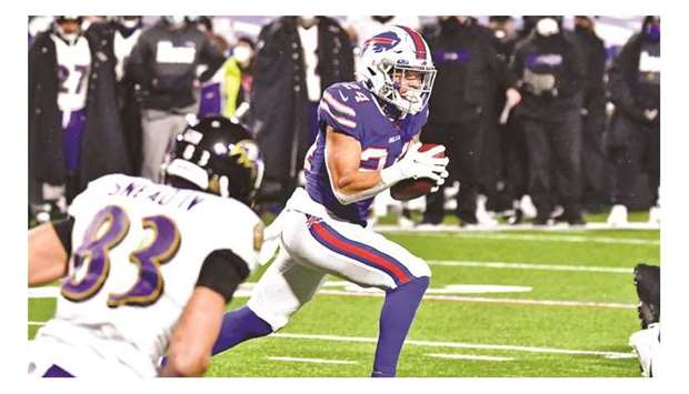 Buffalo Bills cornerback Taron Johnson runs with the ball for a touchdown after making an interception against the Baltimore Ravens during the second half of an AFC Divisional Round playoff game at Bills Stadium in Orchard Park, New York, United States, on Saturday. (USA TODAY Sports)