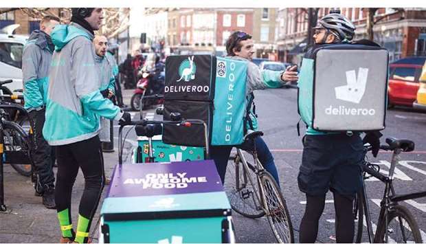 Food delivery cycle couriers chat as they wait for orders from Deliveroo in London. As lockdowns restrict peopleu2019s movement and businesses close, food delivery firms like Deliveroo and Just Eat Takeaway.com NV saw a boost as consumers ordered takeaways from home.