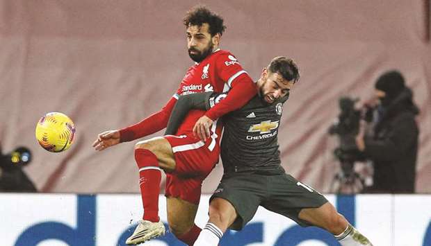 Liverpoolu2019s Egyptian midfielder Mohamed Salah (L) vies with Manchester Unitedu2019s Portuguese midfielder Bruno Fernandes during their English Premier League match at Anfield yesterday.
